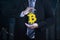 Unknown businessman holding bitcoin symbol