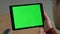 Unknown businessman using chroma key tablet for surfing on workplace closeup