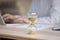 Unknown businesswoman working on laptop, focus on hourglass on desk