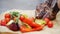 Unknown chef cuts pieces of meat on parchment, which are cooked vegetables