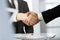 Unknown diverse business people are shaking hands finishing contract signing, close-up. Business and handshake concept