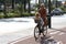 Unknown elderly cyclist rides with a dog on the street of the resort of Malaga