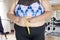 Unknown fat woman measuring her waistline