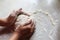 Unknown female hands making dough for pastry, having enough flour on white table, practising baking skills, spending her free time