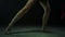 Unknown female legs practicing artistic gymnastics. Gymnast performing ribbon.