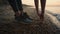 Unknown girl hands reaching to ground on beach close up. Woman training yoga.