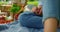 Unknown human legs on picnic blanket closeup. Woman sitting on plaid outdoors.