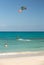 Unknown kitesurfer surfing on a flat azure water of Atlantic ocean in Corralejo