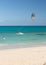 Unknown kitesurfer surfing on a flat azure water of Atlantic ocean in Corralejo