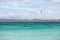 Unknown kitesurfer surfing on a flat azure water of Atlantic ocean in Corralejo, Fuerteventura