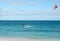 Unknown kitesurfer surfing on a flat azure water of Atlantic ocean in Corralejo, Fuerteventura