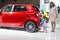 Unknown little girl and a red beautiful car