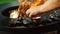 Unknown man grilling mussels outside. Male chef preparing seafood on mangal