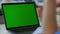Unknown man having video call green screen laptop. Male person waving hand.