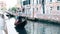 Unknown people ride along the channel on famous gondola in Venice, Italy