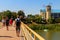 Unknown people walking on pedestrian bridge  across Khorol river in wellness resort Myrhorod