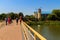 Unknown people walking on pedestrian bridge  across Khorol river in wellness resort Myrhorod