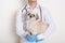 Unknown person vet holding sick pekingese puppy in hands, faceless portrait of veterinarian with patient in veterinary clinic,