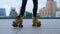 Unknown roller skater dancing. Woman legs doing exercise on rollerblades.