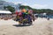 Unknown seller of inflatable toys and swimming laps riding a bicycle hung with toys. Albania. Durres. June 2018