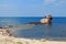 Unknown semi-submerged rusted and destroyed barge stranded in a bay