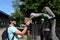 Unknown tourist feeds African ostriches at the Ostrich Ranch contact zoo in Barnaul