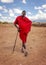 Unknown village near Amboselli park, Kenya - April 02, 2015: Unknown Masai warrior posing for tourists in traditional bright red