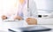 Unknown woman-doctor and female patient sitting and talking at medical examination in clinic, close-up. Therapist