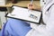 Unknown woman doctor at work at hospital. Pills at medical clipboard. Young female physician write prescription or