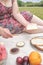 Unknown woman enjoys a healthy breakfast picnic, whole grain bread and fruits