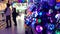 Unknowns customers choose LED Christmas tree lights in a big store