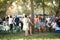 Unlit tiki torch or citronella lantern at garden party with guests out of focus in background