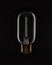 Unlit tungsten filament light bulb on black