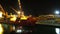 Unloading Cargo from a Ship in the Sea Port of Batumi by Night. Time Lapse