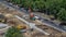 Unloading concrete plates from truck by crane at road construction site timelapse.