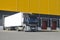 Unloading trucks in a modern warehouse complex. Transportation, storage