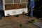 Unloads biological waste from the body of a truck. the man has opened the lid and will tip the contents of the cargo at the compos