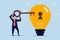 Unlock new business idea, smart businessman holding golden key about to insert into key hold on lightbulb idea lamp