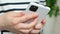 Unlock smartphone with fingerprint, woman holding mobile phone, hands close-up