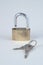 Unlocked brass padlock with keys