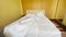 unmade bed bedroom house. bed a early morning bed sheet. white linens in the hotel. unmade bed early morning in