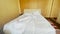 unmade bed bedroom house. bed a early morning bed sheet. white linens in the hotel. unmade bed early morning in bedroom