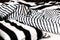 Unmade bed in black and white stripes. Close-up