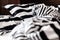 Unmade bed in black and white stripes. Close-up