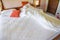 Unmade bed sheet of the crease and pillow white blanket in the bedroom after sleep on top view - Wrinkled fabric sunlight in the