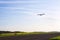 Unmanned aerial vehicle surveillance drone with light and camera landing on airport runway, ground, airfield, sunny morning