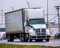 An Unmarked Tractor Trailer Leads Traffic On A Wet Day