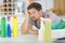 unmotivated man surrounded by cleaning products