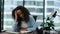 Unmotivated woman office worker tired of work sitting modern desk close up.