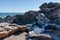 Unnamed grave and cross in natural setting between rocks with sea in background, Luderitz Peninsula, Namibia, Africa